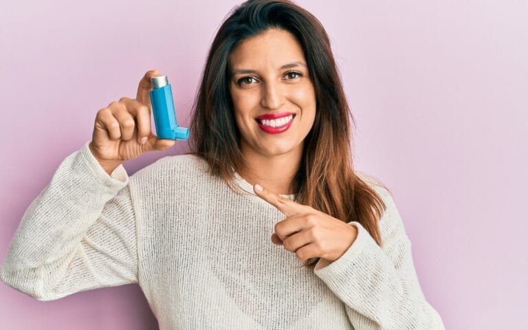 Woman holding asthma inhaler